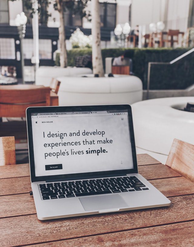 Laptop with quote: “I design and develop experiences that make people’s lives simple.”