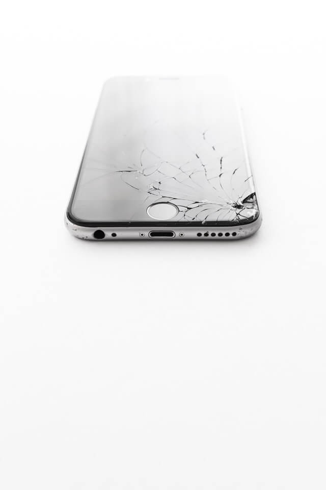 an iPhone with damage to the bottom of the screen